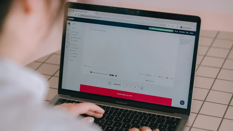 A person works at a laptop in a content production environment.