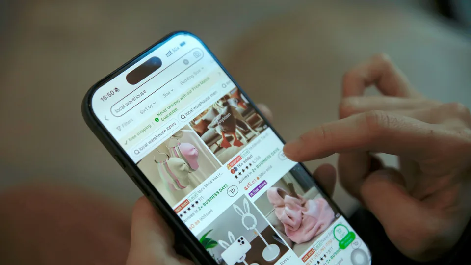 A shopper browses an online marketplace on a smartphone; the photograph is illustrative, not a Google interface.