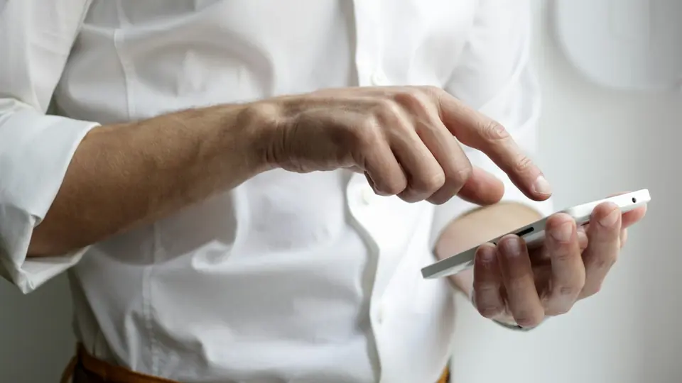 A person holding a smartphone, contextual photography for an article about real-time voice software.